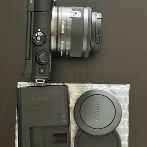 Canon Black and Silver Mirrorless Camera with Lens